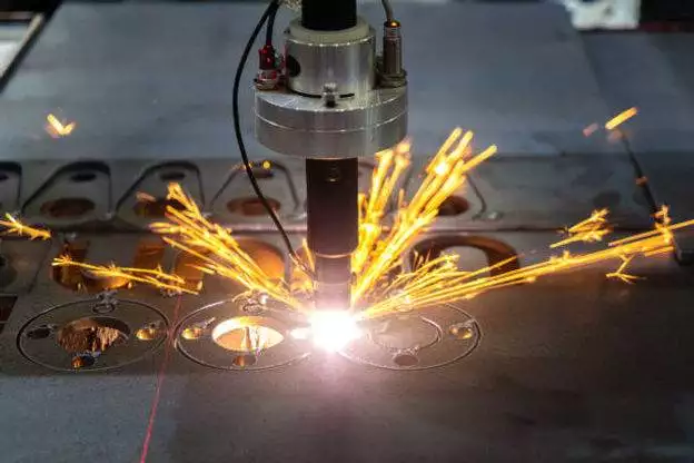 A person is using laser technology for custom metal fabrication.
