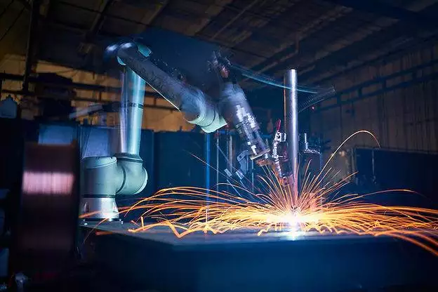 A robot is custom metal fabrication in Ontario factory.